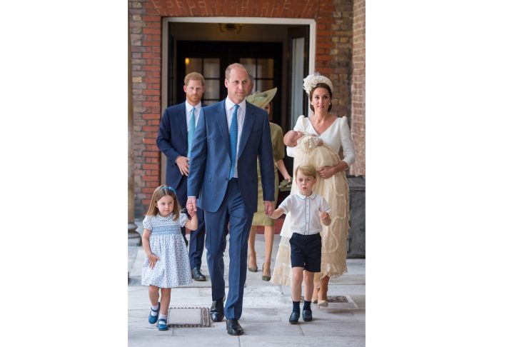 Britain’s Princess Charlotte and Prince George hold the hands of their father, the Duke of Cambridge, as they arrive for the christening of their brother, Prince Louis, who is being carried by the Duchess of Cambridge, at the Chapel Royal
