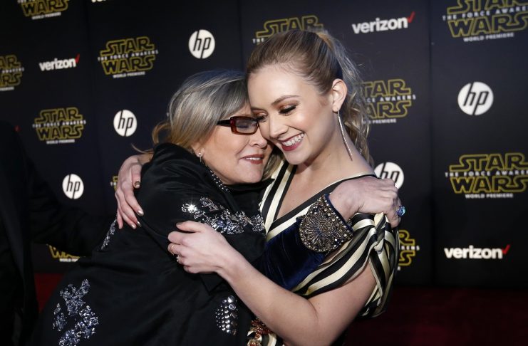 Actresses Carrie Fisher and Billie Lourd embrace as they arrive at the premiere of “Star Wars: The Force Awakens” in Hollywood