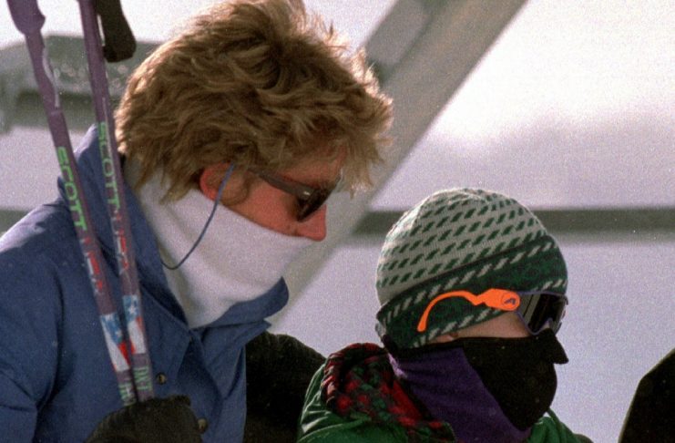 The Princess of Wales (L) and her son Prince Harry (R) cover their faces while being brought up by a..