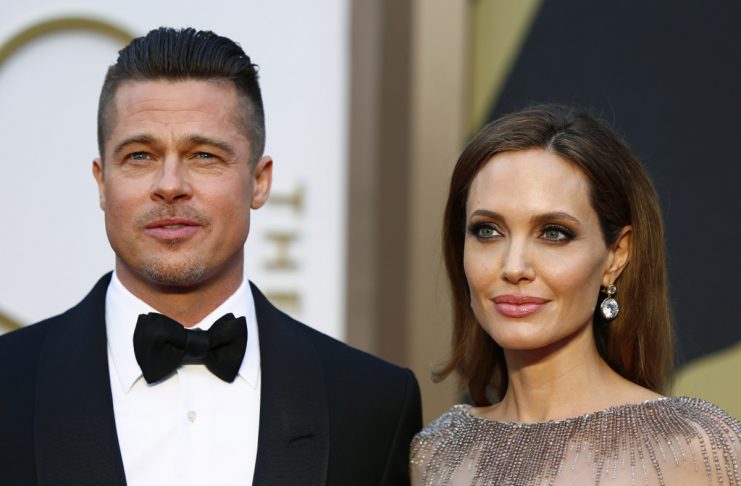 Actors Brad Pitt and Angelina Jolie arrive at the 86th Academy Awards in Hollywood
