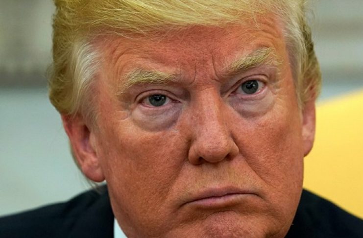 Trump looks up as reporters ask questions about Tillerson at the White House in Washington