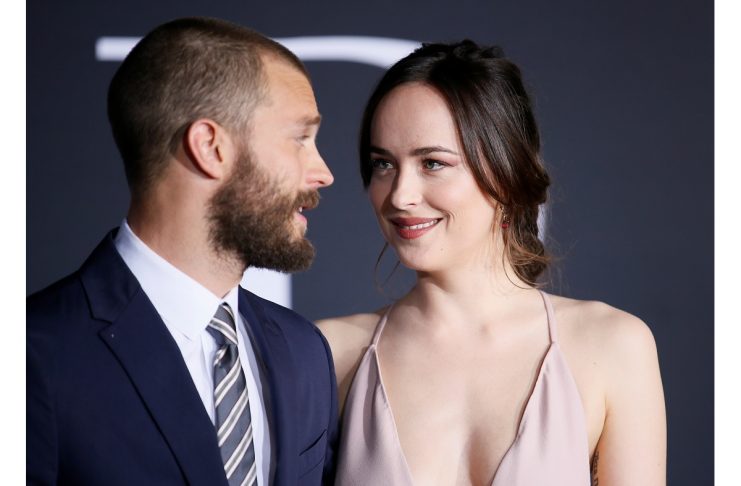 Cast members Jamie Dornan and Dakota Johnson pose at the premiere of the film “Fifty Shades Darker” in Los Angeles, California
