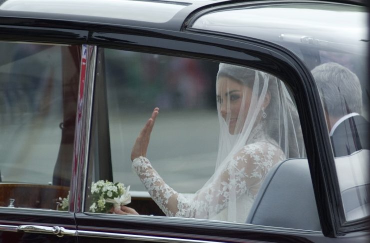 Kate Middleton waves to the crowd on her way to Westminster Abbey in central London