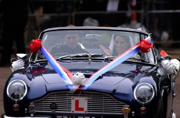 Britain’s Prince William and his wife Catherine, Duchess of Cambridge drive from Buckingham Palace in Aston Martin DB6 Mark 2 after their wedding in Westminster Abbey in London