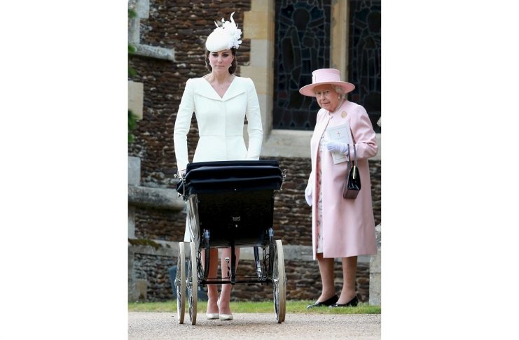 Catherine, Duchess of Cambridge pushes Princess Charlotte of Cambridge in her pram as Queen Elizabeth looks on as they leave the Church of St Mary Magdalene