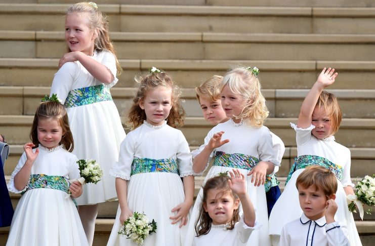 The bridesmaids and page boys, including Prince George and Princess Charlotte, wave as they leave after the royal wedding of Britain’s Princess Eugenie of York and her husband Jack Brooksbank at St George’s Chapel in Windsor Castle