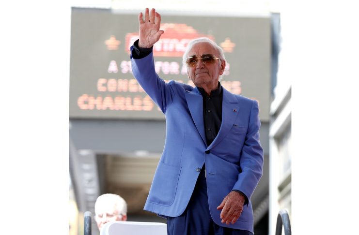 Armenian-French singer Aznavour waves before unveiling his star on the Hollywood Walk of Fame in Los Angeles