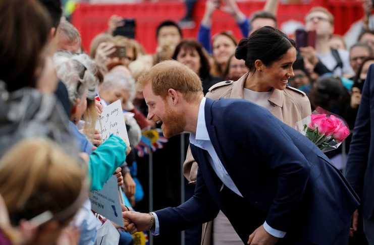Britain’s Prince Harry and Meghan, Duchess of Sussex, greet people at Viaduct Harbour in Auckland