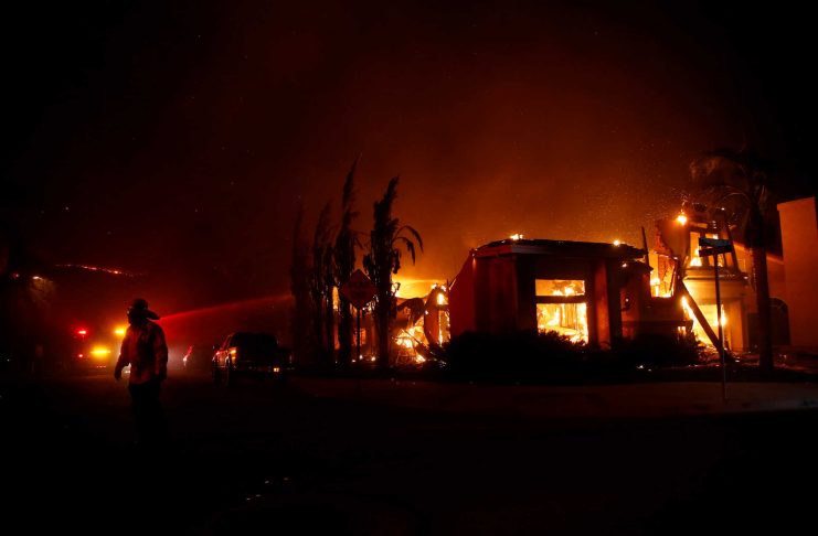 Firefighters battle flames overnight during a wildfire that burned dozens of homes in Thousand Oaks