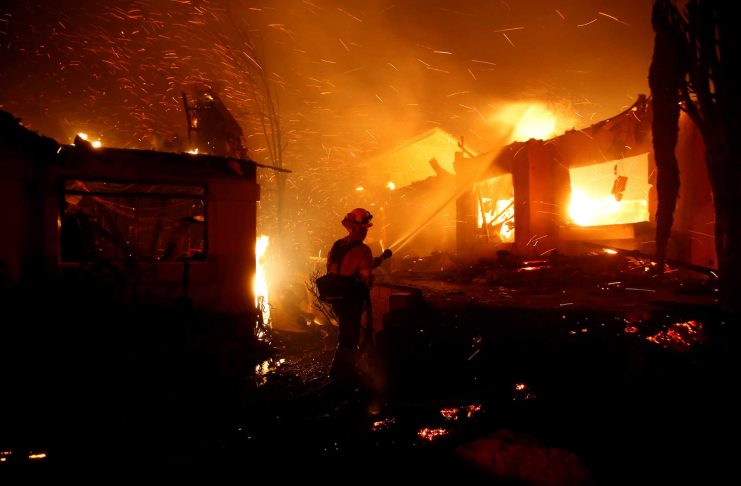 Firefighters battle flames overnight during a wildfire that burned dozens of homes in Thousand Oaks