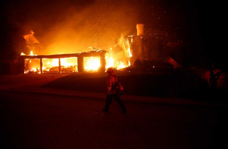 Firefighters battle flames overnight during a wildfire that burned dozens of homes in Thousand Oaks