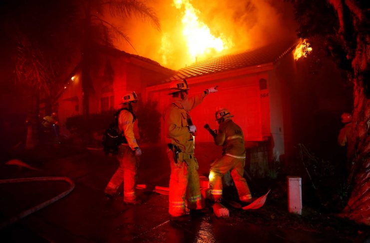 Firefighters battle flames overnight during a wildfire that burned dozens of homes in Thousand Oaks
