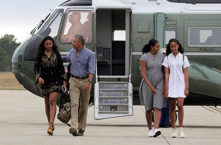 U.S. President Barack Obama, U.S. first lady Michelle Obama and their daughters Malia and Sasha board Air Force One at Cape Cod Coast Guard Air Station in Buzzards Bay, Massachusetts